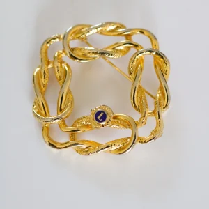 Broche en métal doré Lions International